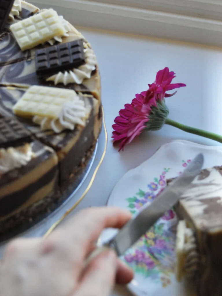 A photo of someone about to cut into a slice of the cake.